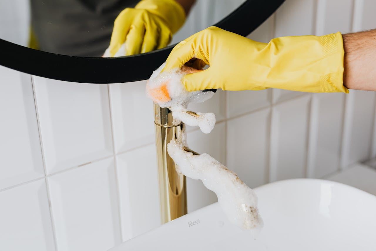 Gloved hand scrubbing faucet