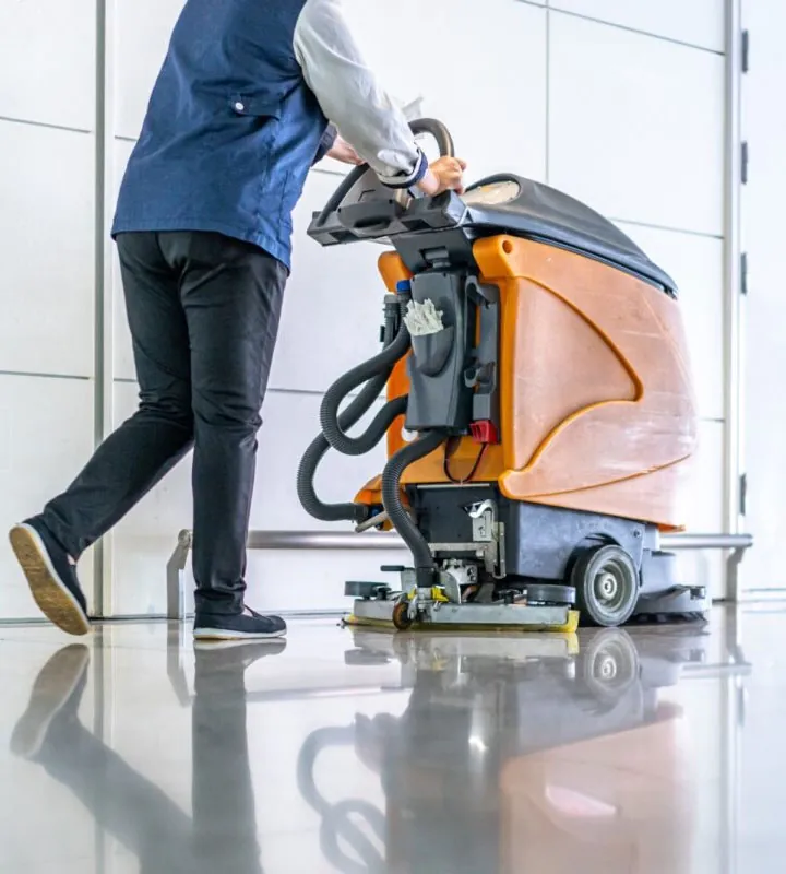 Janitor pushing cleaning machine