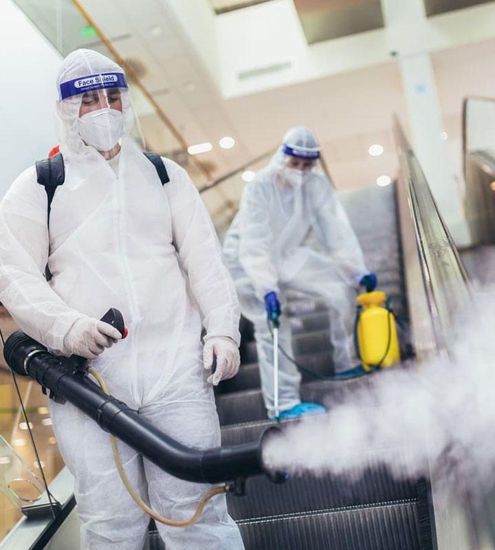 Cleaner disinfecting an escalator