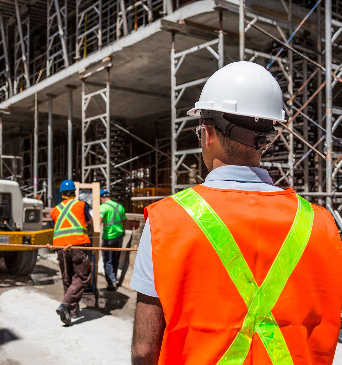 Construction worker in front of cement truck